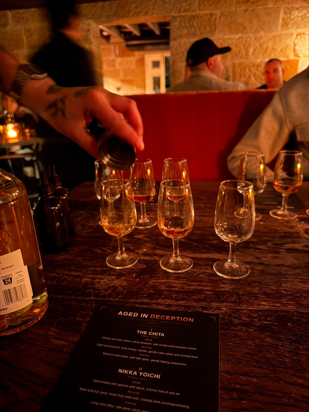 Japanese whisky poured into tasting glasses at a Sydney whisky tasting and magic show